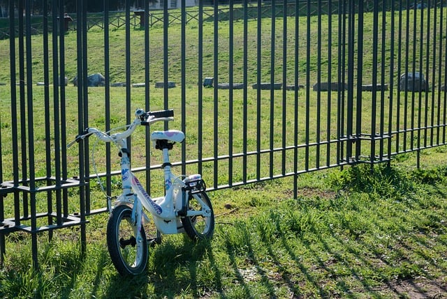 Child’s bicycle beside a fence symbolizing grief support from funeral homes in Royal Oak, MI